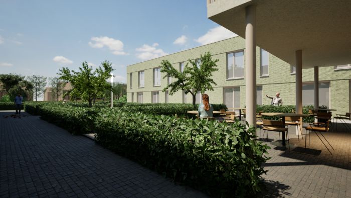 Buitenruimte van nieuw zorgcomplex Levanto Kerkrade met groene hof, zitplekken en wandelpaden voor bewoners.