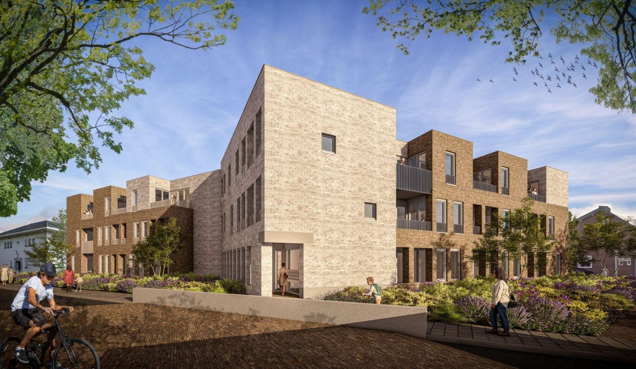 D’r Burggraaf Gulpen – impressie van hoekblok in licht en donker baksteen met balkons, entreepassage en bloemrijke beplanting