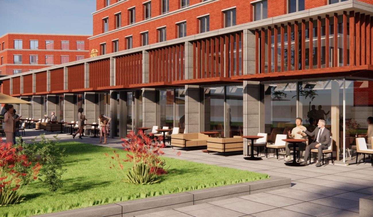 Impressie Van der Valk Maastricht-Maas: terras met houten lamellen en glazen gevel