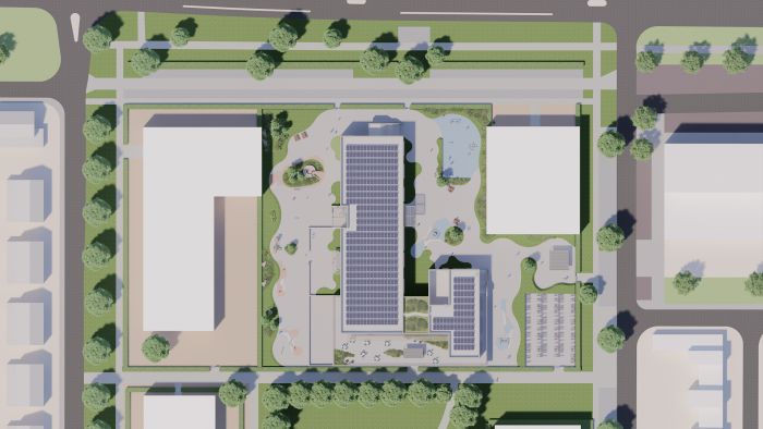 Kernkindcentrum Maastricht-West – impressie van licht bakstenen school met brede buitentrap, speelplein en groen ingericht terrein